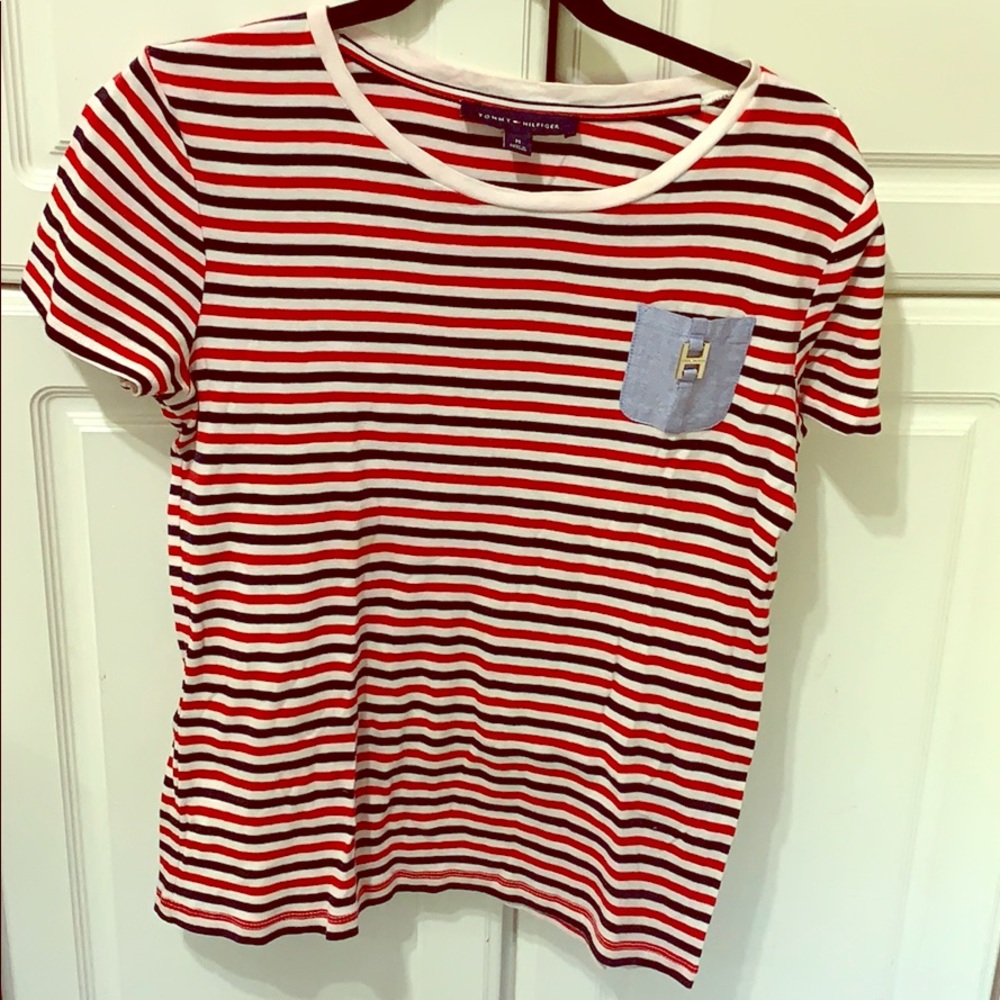 Tommy checks tee